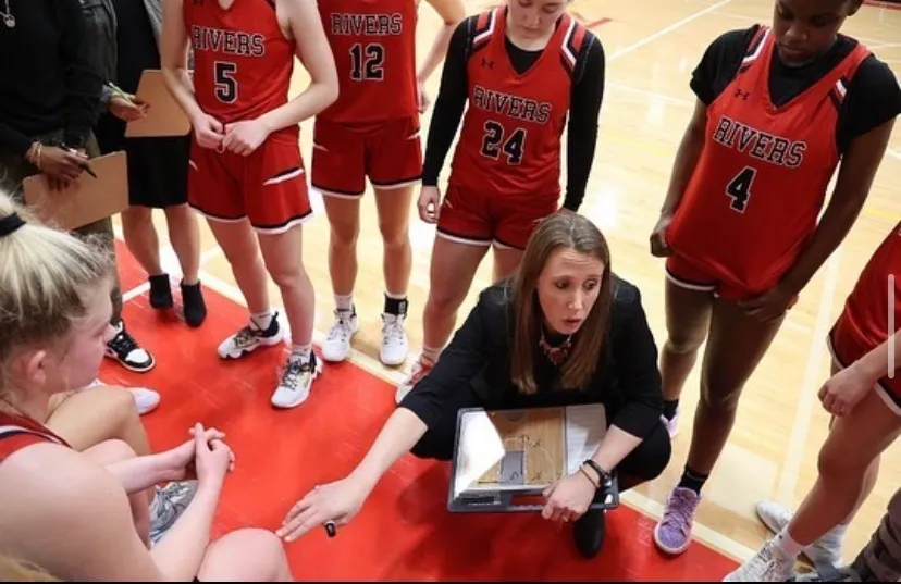 A group of women in red jerseys on the court.