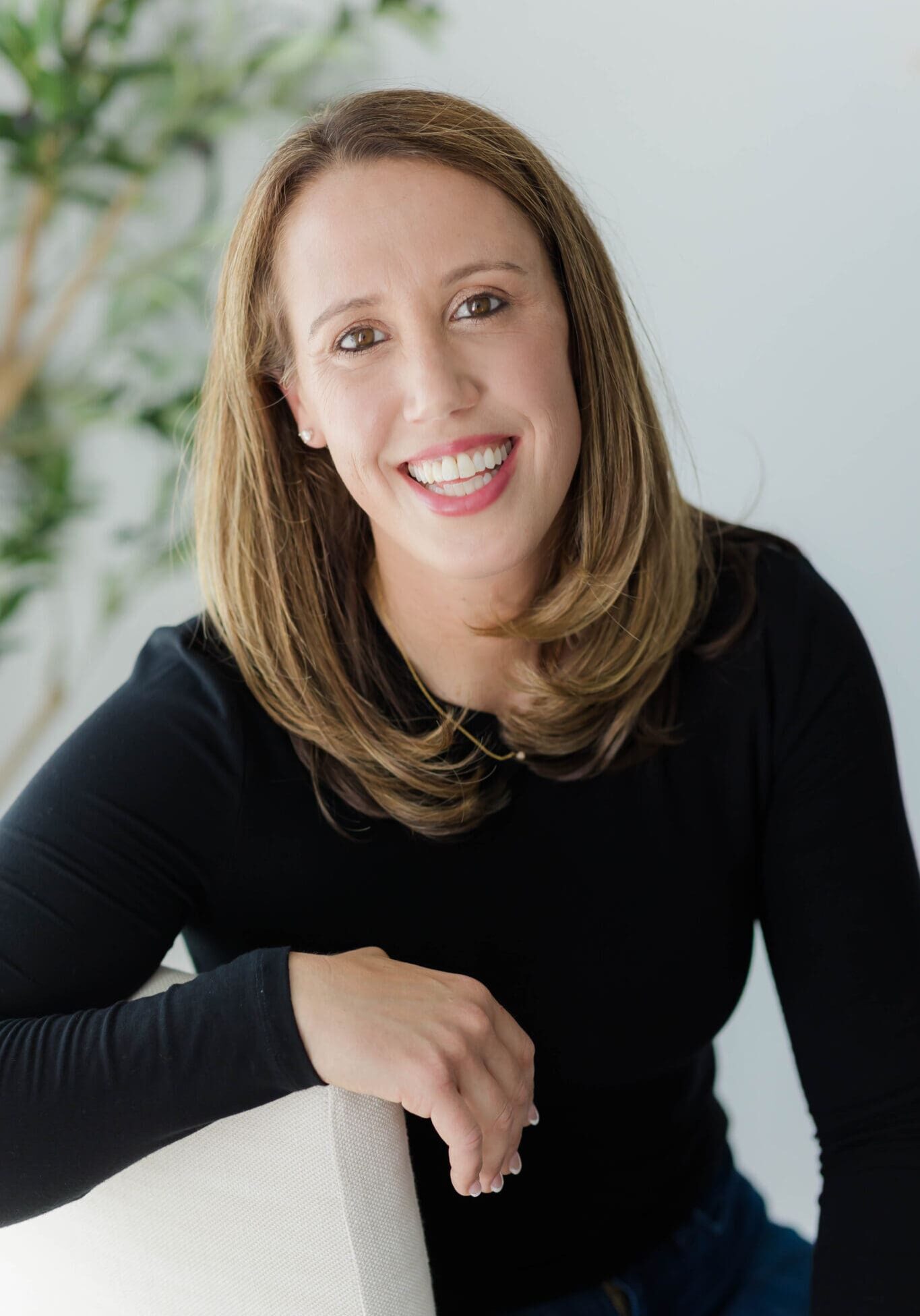 A woman in black shirt smiling for the camera.